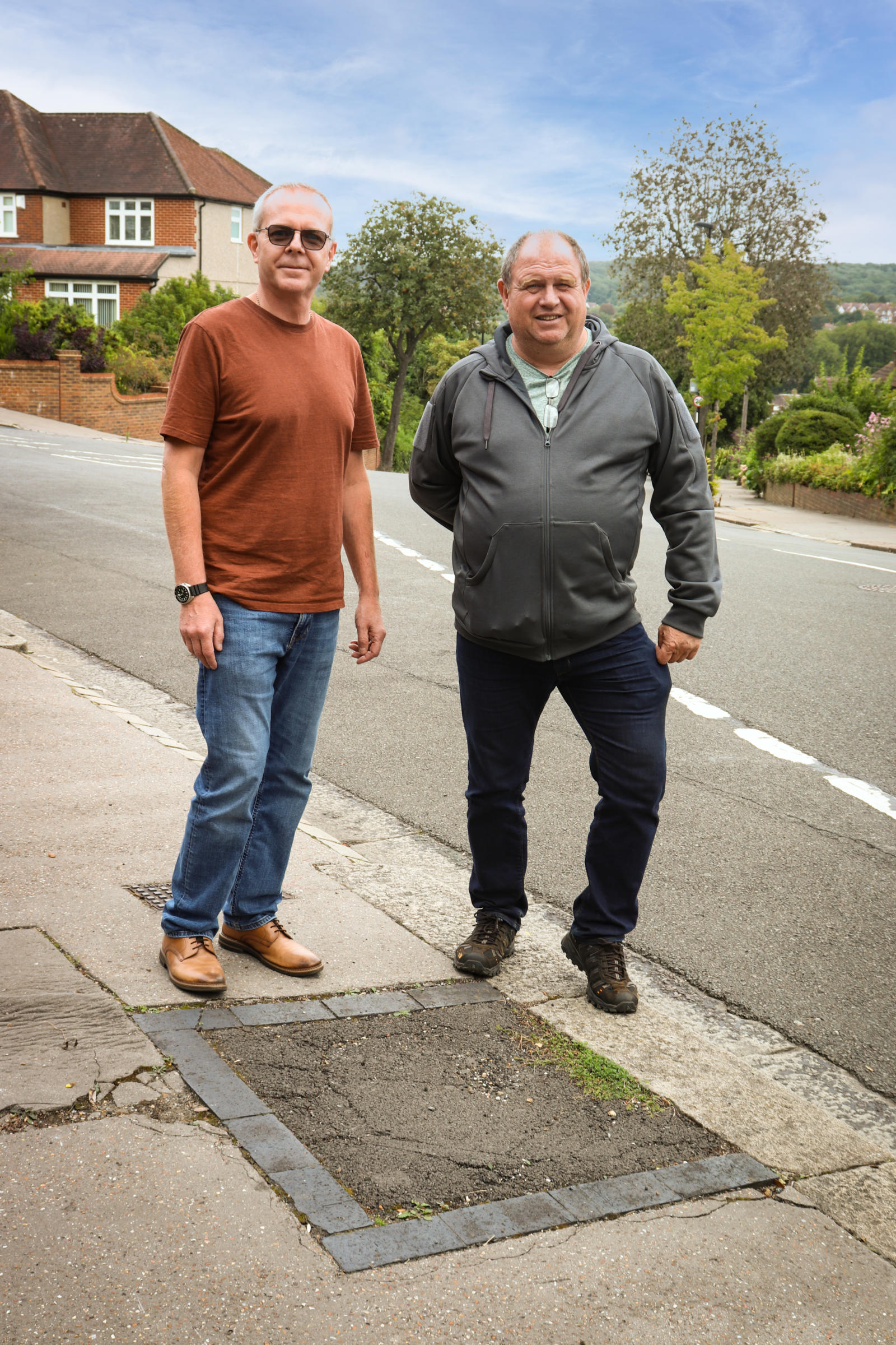 Gavin stood with council tree officer Richard next to an empty tree pit