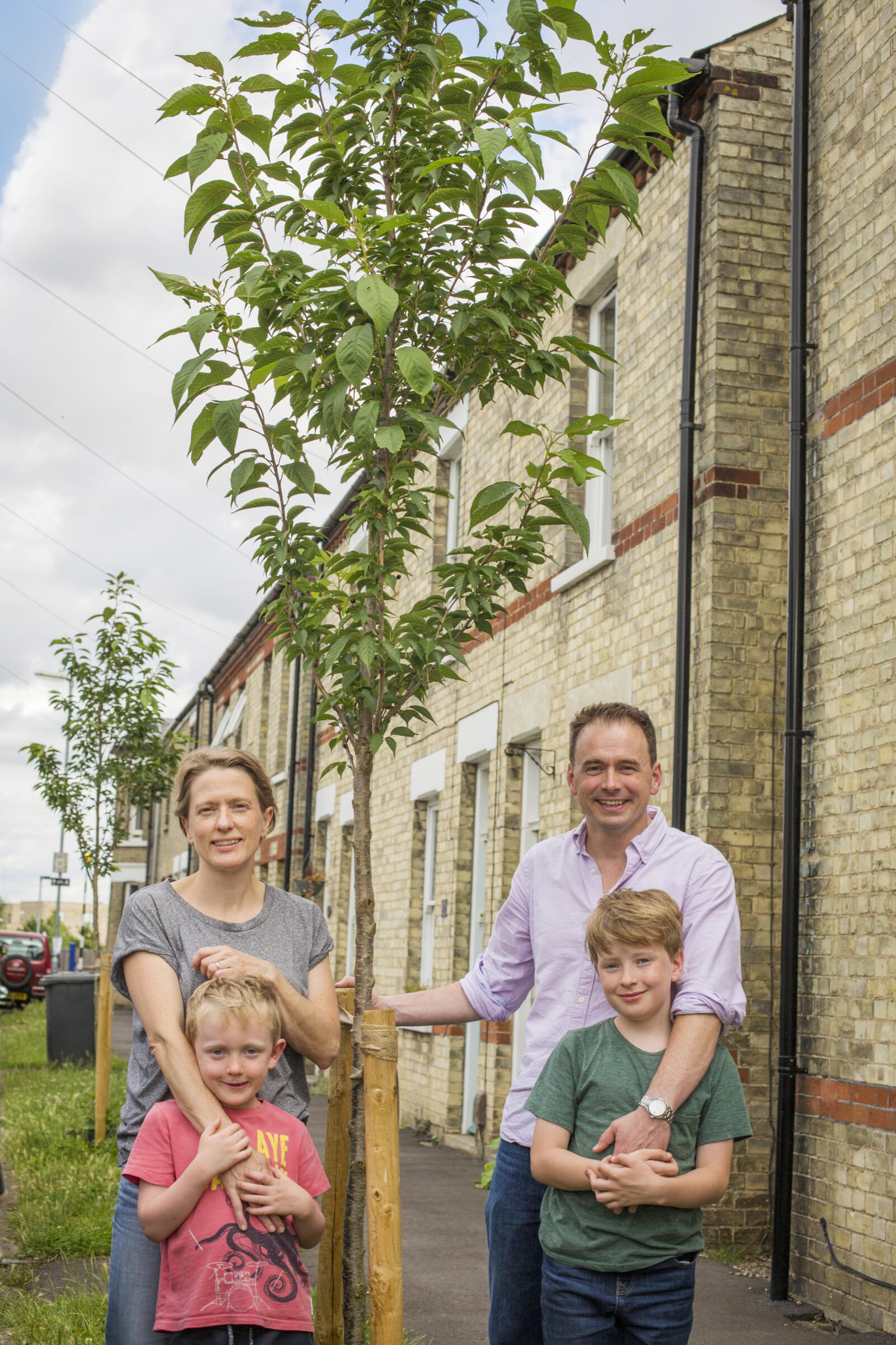 Tom and Cat with their two boys and their newly sponsored street tree