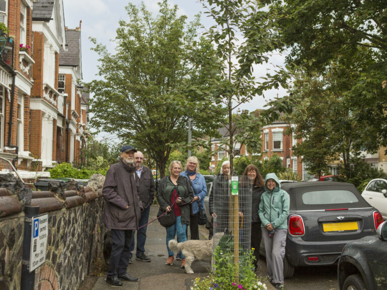 Helen and her neighbours around one of the sponsored trees
