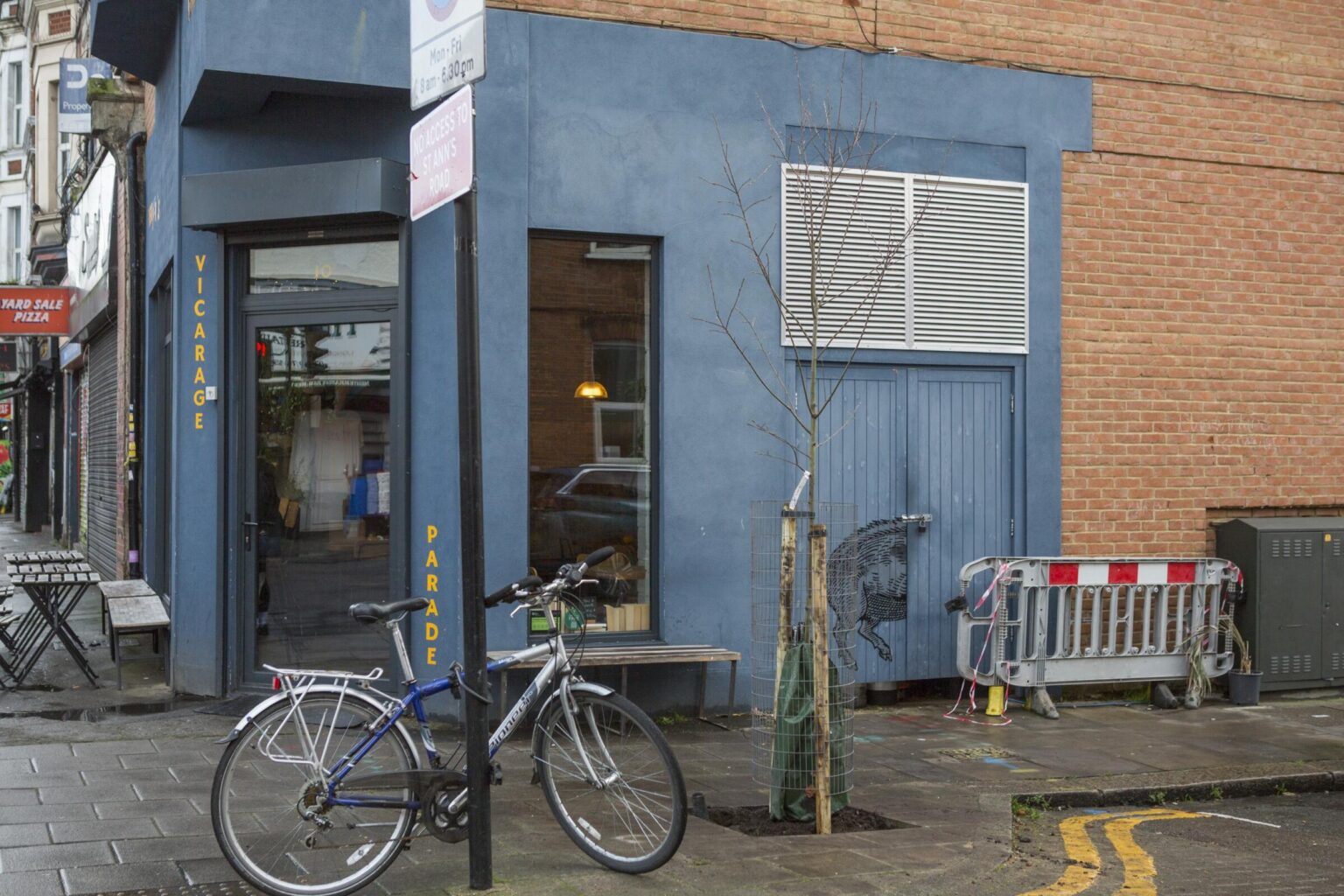 a new tree stands outside a cafe